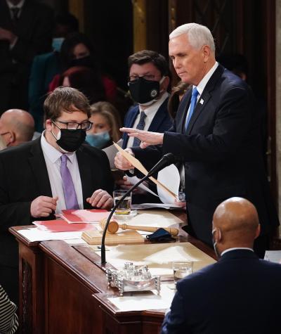  U.S. Vice President Mike Pence and U.S. House Speaker Nancy Pelosi, along with other staff, take part in a joint session of the Congress to certify the 2020 election results at the U.S. Capitol.