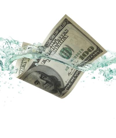 A $100 bill dropping into water against a white background