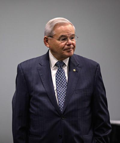 Bob Menendez standing in front of a gray wall